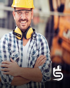 Happy engineer with hardhat and noise cancelling headphones